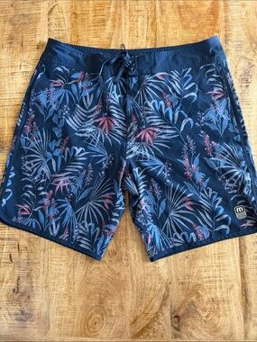 Travis Mathew Navy Tropical Board Shorts with Red Accents